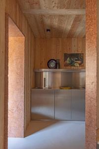 a kitchen with a stainless steel counter in a room at Herbighe Retreat in Asiago +2 photos