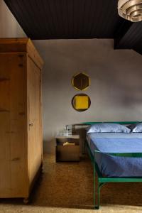 a bedroom with a bed and a cabinet and a table at Herbighe Retreat in Asiago