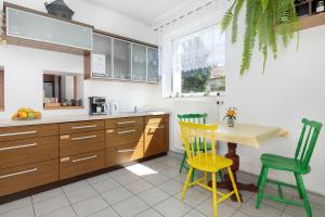 a kitchen with wooden cabinets and a table and chairs at Hołcyna 21 in Brenna +55 photos
