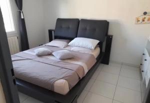 a bed with two pillows on it in a room at Maison de vacance Montpellier in Montpellier