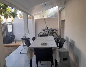 a table and chairs on a patio with a bike at Maison de vacance Montpellier in Montpellier