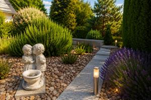 a statue of two children with a fountain in a garden at Relax Ferienwohnung in Odernheim