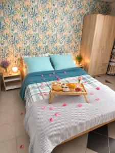 a bed with a tray of food on it at Relax Ferienwohnung in Odernheim