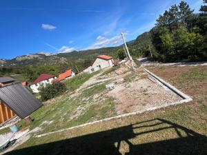 a view of a farm with mountains in the background at Montenegro pines in Bistrica Lipovska +9 photos