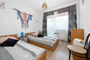 a bedroom with two beds and a window at Hołcyna 21 in Brenna