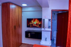a bathroom with a fire fireplace in the wall at Kakamega bransoncomfort in Kakamega