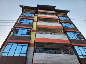 a tall building with many windows at Kakamega bransoncomfort in Kakamega
