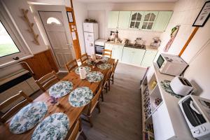 an aerial view of a kitchen with a table and chairs at Gyarmati Vendégház Sirok in Sirok