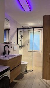 a bathroom with a sink and a toilet and a window at Ferienhaus Am Vitzerod in Tambach-Dietharz +16 photos