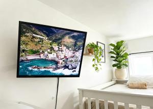 a flat screen tv hanging on a wall in a bedroom at CROKE PARK STUDIO in Dublin