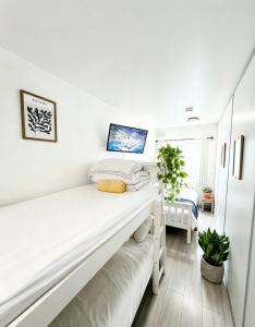 a bedroom with white walls and a white bunk bed at CROKE PARK STUDIO in Dublin