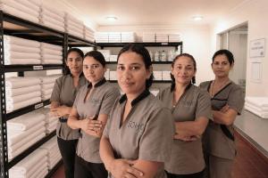 a group of people standing in a store at Neos Apartments – Near the Sea by SOHO in Santa Marta