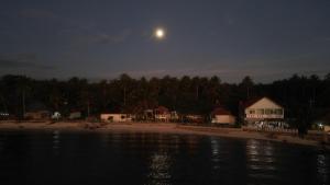 a view of a beach at night with the moon at Karang Besi Losmen in Biha +3 photos
