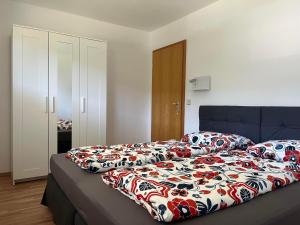 a bedroom with a bed with a blanket on it at Ferienwohnung Heid in Rettenberg