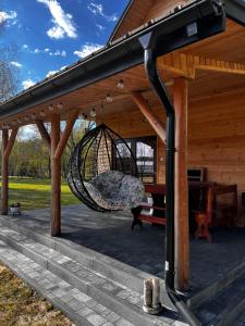 a swing hanging from a gazebo at Brzozowe Zacisze in Narol