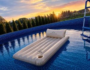 a white inflatable bed in a swimming pool at Tatra House z Jacuzzi in Poronin