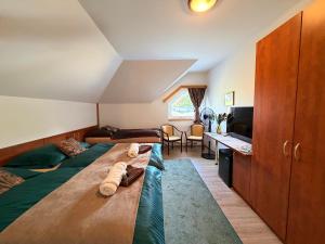 a bedroom with two beds and a tv and a desk at Restaurace Staré Sedlo in Orlík