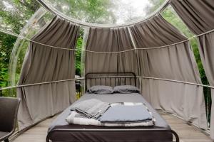 a bedroom with a bed in a tent at Studio Capsule House in Parry Sound #32 in Parry Sound