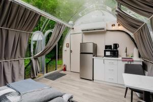 a room with a kitchen and a refrigerator in a house at Studio Capsule House in Parry Sound #32 in Parry Sound +15 photos