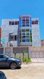 a car parked in front of a building at Hotel Mardoche Banto in Luanda
