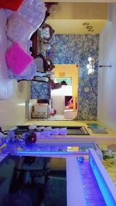 a room with a vanity with a mirror and a table at Hotel Mardoche Banto in Luanda