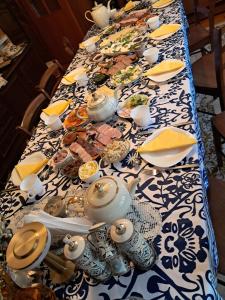 a long table with a blue and white table cloth at Olsik in Białowieża +47 photos