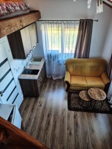 a living room with a couch and a table at Zeigių apartamentai in Normantai