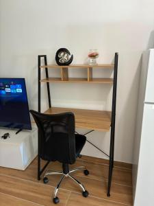 a black chair sitting in front of a desk at NovaStay in Breuillet