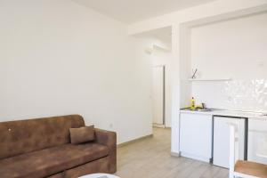 a living room with a couch and a kitchen at Rasi Luxury Apartments in Ulcinj