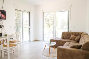a living room with a couch and a table at Rasi Luxury Apartments in Ulcinj