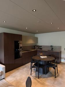 a kitchen with a table and chairs in a room at The Cozy Nook - Modern scandinavisk Studio in Kristianstad +3 photos