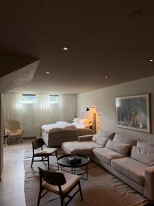 a living room with a couch and a bed at The Cozy Nook - Modern scandinavisk Studio in Kristianstad