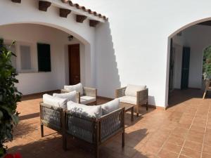 a patio with couches and chairs in a building at 6 person house with private pool and garden in Trebeluger