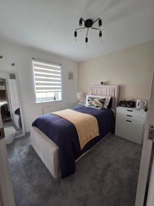 a bedroom with a large bed and a window at Hampton Water Rooms Peterborough in Peterborough
