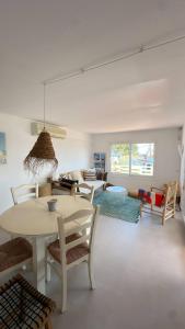 a living room with a table and chairs and a couch at House close to the beach of Punta Prima in Punta Prima