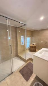 a bathroom with a shower and a sink at House close to the beach of Punta Prima in Punta Prima +26 photos