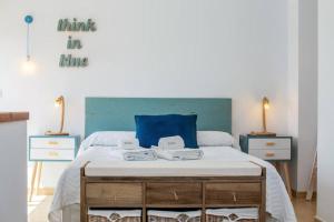 a bedroom with a large bed with a blue pillow at Stunning duplex with two terraces in Cala Blanca in Son Carrio +19 photos