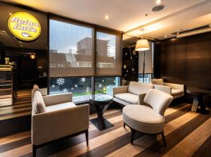 a waiting room at a restaurant with chairs and a table at Hotel Relax I in Taipei