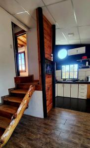 a room with stairs and a kitchen in a house at Casa Petricor in Río Tercero
