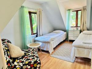 a small room with two beds and a couch at Systrarna på Kivik in Kivik