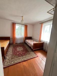 a bedroom with two beds and two windows at Dream house in Türgen