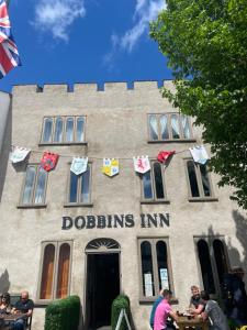 people sitting at tables in front of a building at Dobbins Inn in Carrickfergus