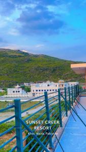 a view from the top of a building with a fence at Sunset Creek in Harīpur