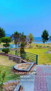 a park with a sign that reads sunset creep resort at Sunset Creek in Harīpur