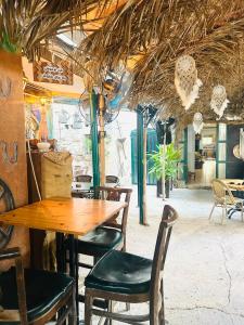 a dining room with a wooden table and chairs at Al Yakhour Hostel in Haifa