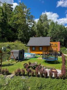 a house with a playground in the yard at Willa Wilk in Międzybrodzie Bialskie