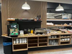 a kitchen with a counter with food on it at Suntel Łeba in Łeba