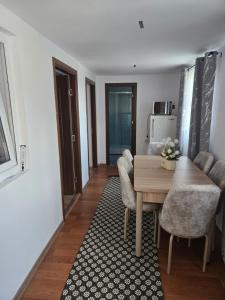a living room with a wooden table and chairs at Casa Valor in Lacu Rosu +23 photos