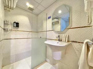 a bathroom with a sink and a shower with a mirror at ODST AL Madinah Hotel - فندق اودست المدينة in Medina +16 photos
