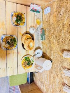 a room with plates of food on a wall at Aalam ordo in Shabdan +6 photos